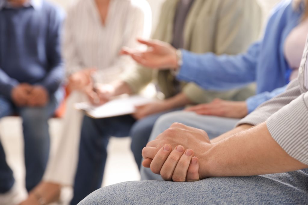 group session discussing halfway houses and recovery support