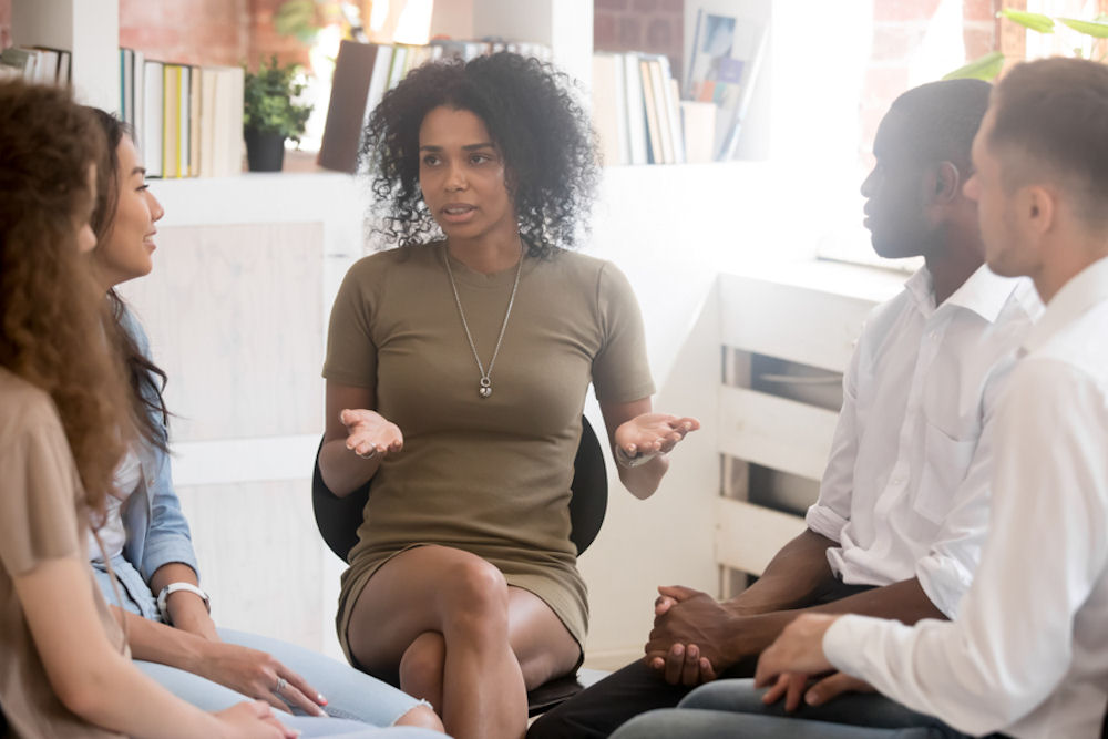 woman explains halfway house vs. sober living in group